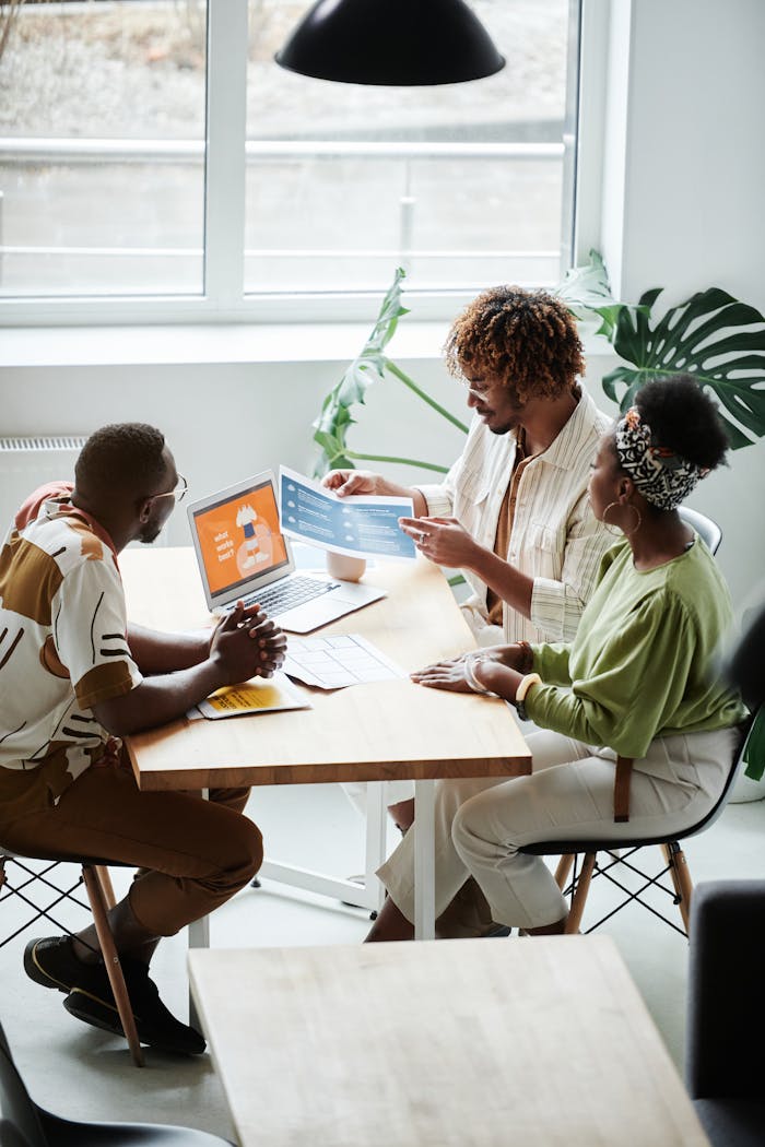 A diverse team engaged in a collaborative business meeting in a bright, modern office setting.